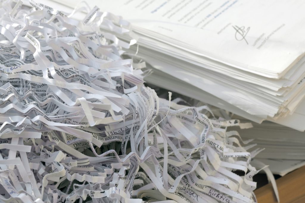 paper shredding confidential documents being shredded