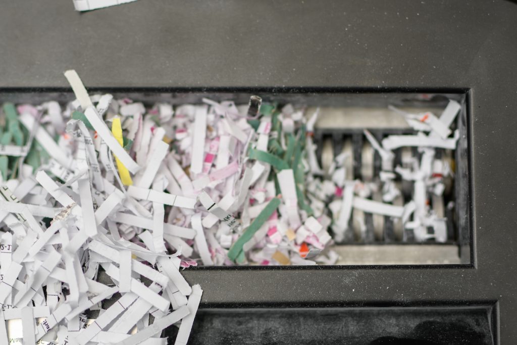 paper shredding jammed paper from blade of office shredder